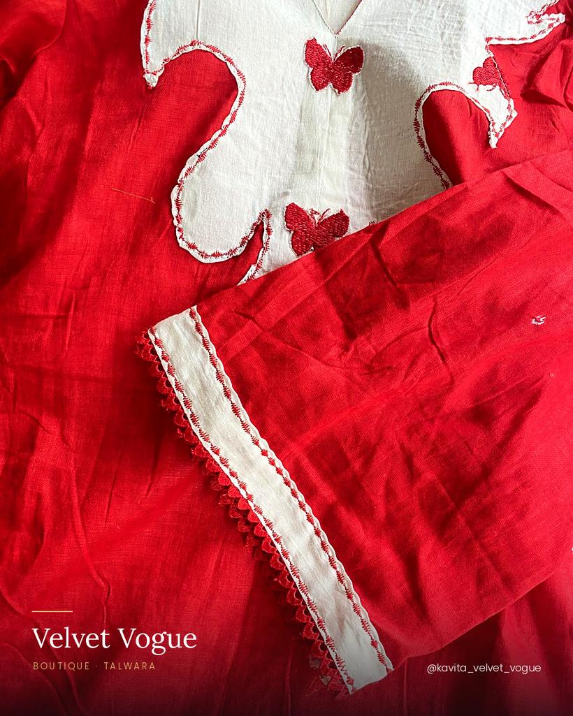 A white petal yoke on red, with a butterfly appliqué and pom-pom lace at the cuff.
